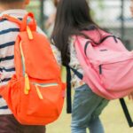 three-pupils-primary-school-go-hand-hand-boy-girl-with-school-bags-back-beginning-school-lessons-warm-day-fall-back-school-little-first-graders_1253-1134