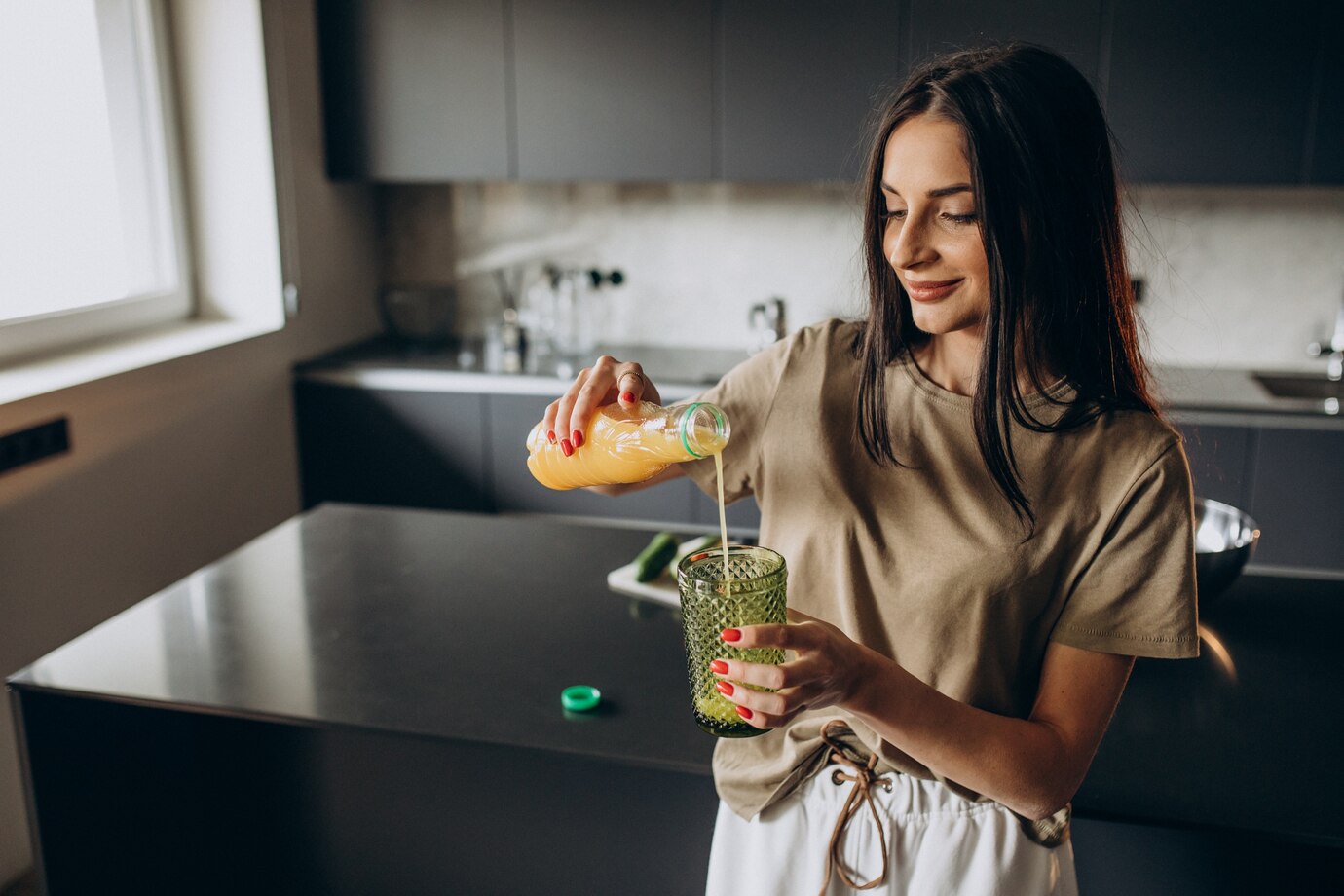 young-woman-drinking-juice-home_1303-24177