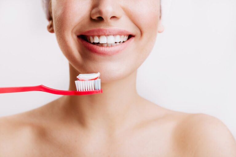girl-with-sincere-smile-makes-morning-routine-brushes-her-teeth-isolated-wall_197531-13926