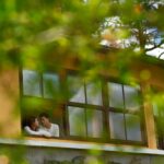 long-shot-couple-cuddling-terrace-mansion_1098-19327