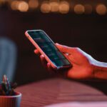 side-view-man-holding-smartphone-hand_23-2148793498