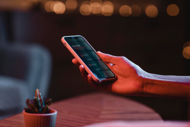 side-view-man-holding-smartphone-hand_23-2148793498