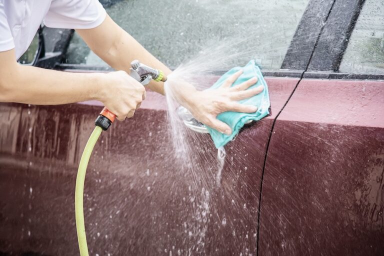 Man washing car using spray jet water - home people car clean concept