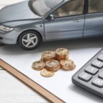 car-model-calculator-coins-white-table_1387-584