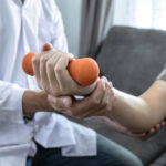 Doctor,Physiotherapist,Treating,Rehabilitation,Arm,Pain,Patient,Doing,Physical,Therapy