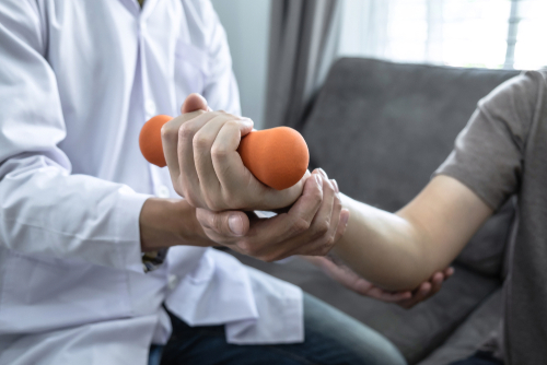 Doctor,Physiotherapist,Treating,Rehabilitation,Arm,Pain,Patient,Doing,Physical,Therapy