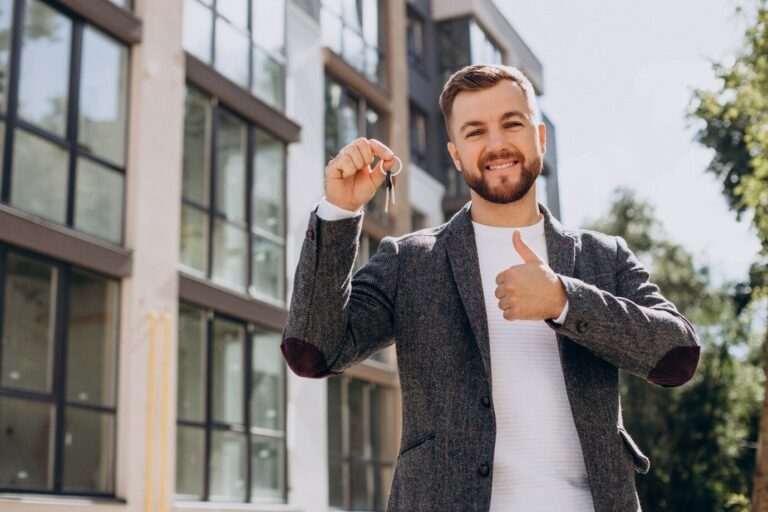 young-man-with-keys-just-bought-new-appartment_1303-28898