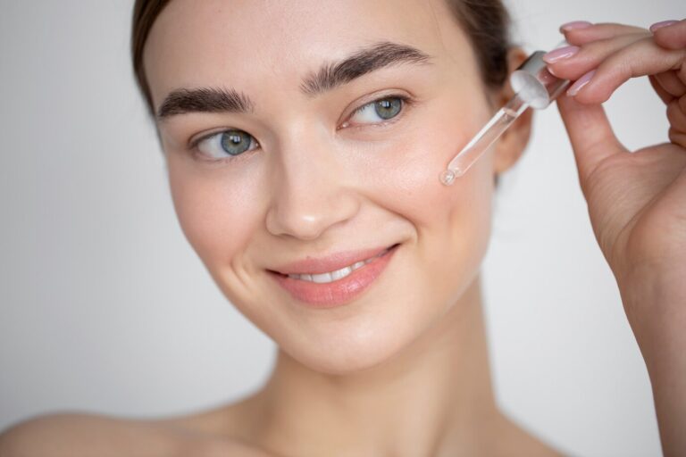 portrait-beautiful-woman-with-clear-skin-using-face-serum_23-2149207918