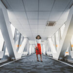 Wide-angle,View,Of,A,Stately,African-american,Businesswoman,In,A,Red