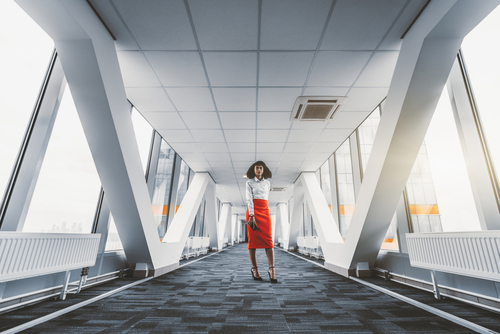 Wide-angle,View,Of,A,Stately,African-american,Businesswoman,In,A,Red