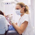 dentist-examining-female-patient_107420-65395